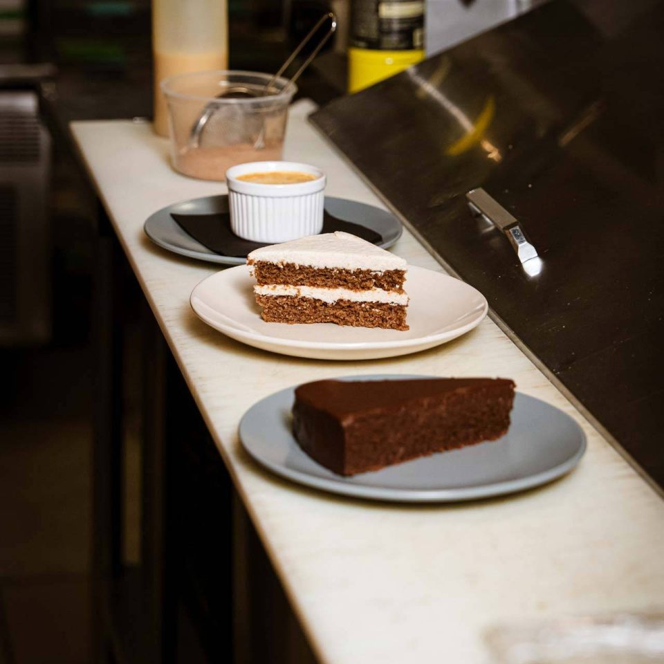 Dessert lineup with layered cake and flourless chocolate