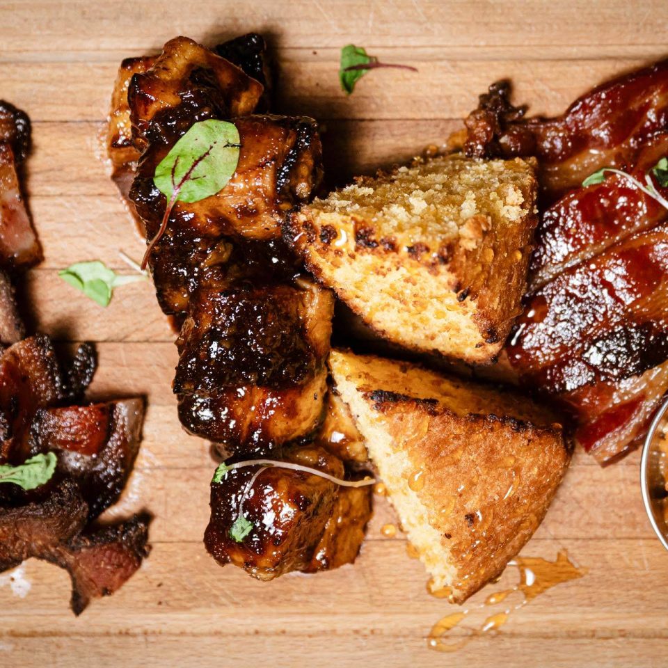 Brunch board with glazed pork belly and cornbread