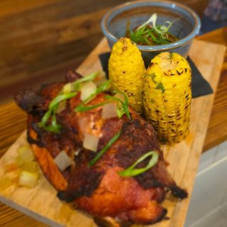 Half smoked chicken with charred corn on the cob
