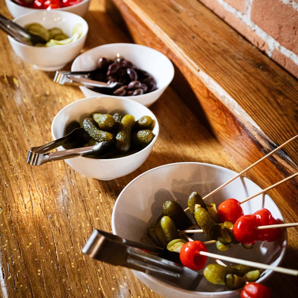Bloody Mary garnish bar with pickles, olives, and skewers