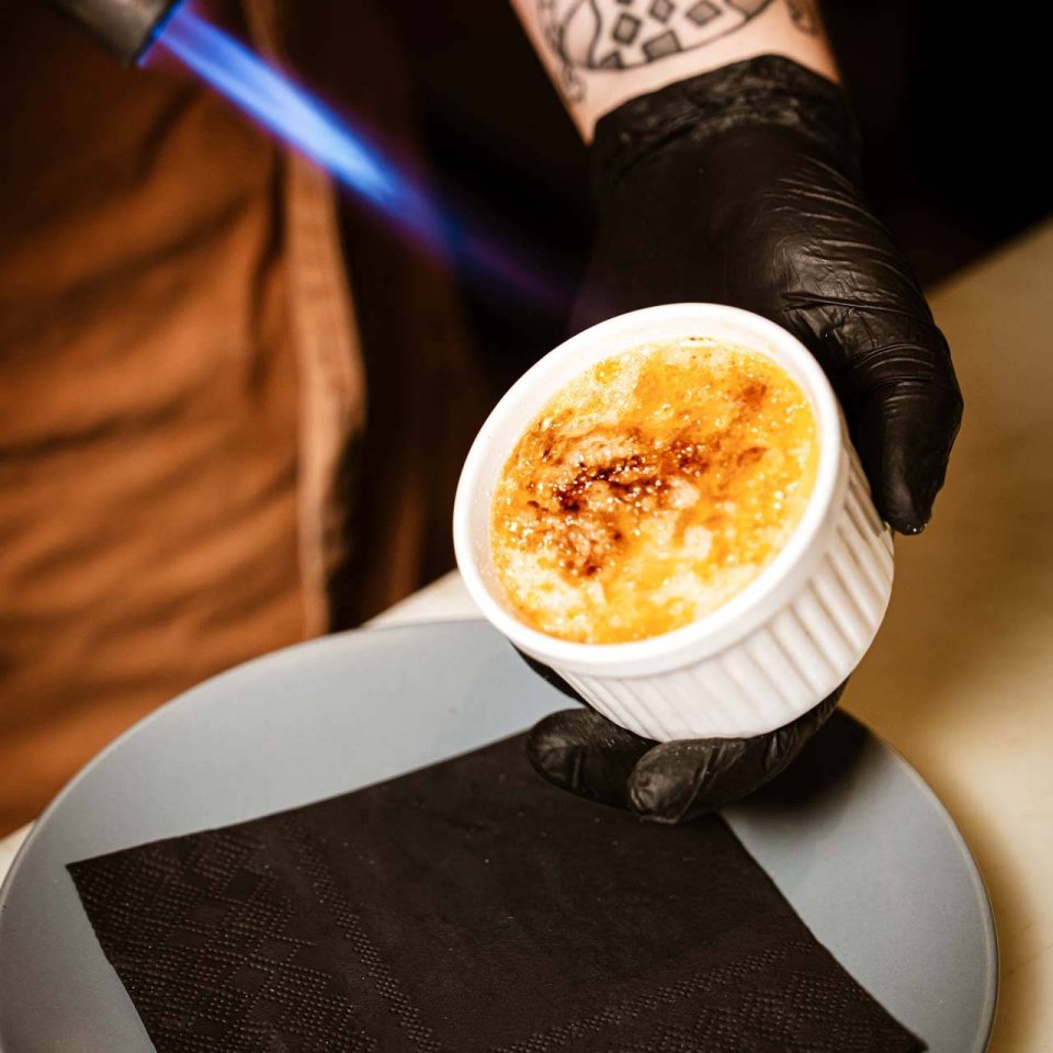 Torching the sugar top of a crème brûlée