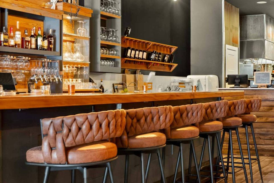 Bar with leather stools and wine display